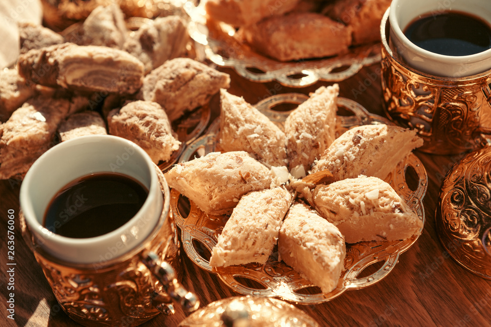 Turkish sweets with coffee on a wooden table Turkish sweets with coffee on a wooden table