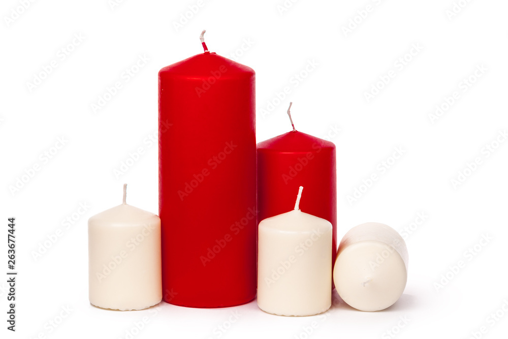 Red and white colored xmas candles isolated on white background Red and white colored xmas candles isolated on white background