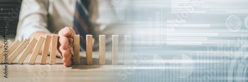 Fotografie Concept of business control by stopping domino effect