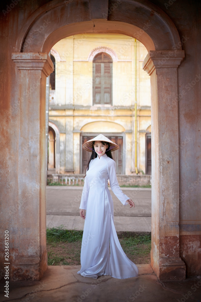 Beautiful woman with Vietnam culture traditional dress, Ao dai, in old resident