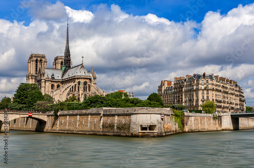Notre-Dame de Paris cathedral and parisian building as seen from Seine river.