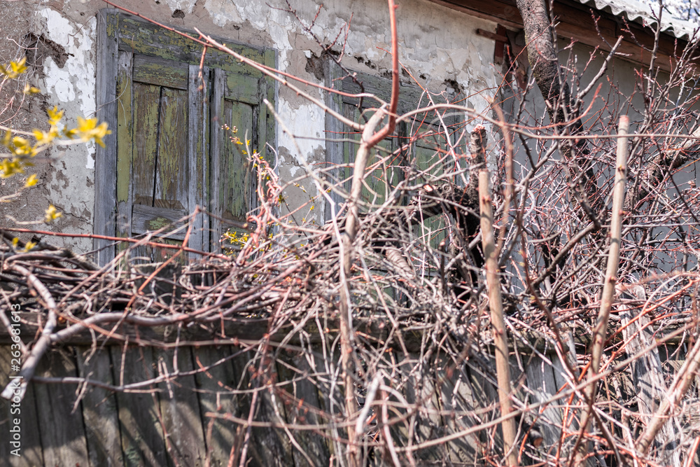 Old abandoned house with closed wooden shutters Old abandoned house with closed wooden shutters