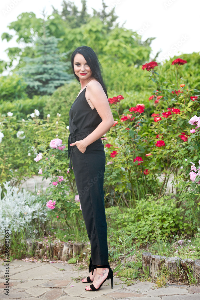 Beautiful fashionable girl in rose garden. Series. Gardening. Beautiful fashionable girl in rose garden. Series. Gardening.