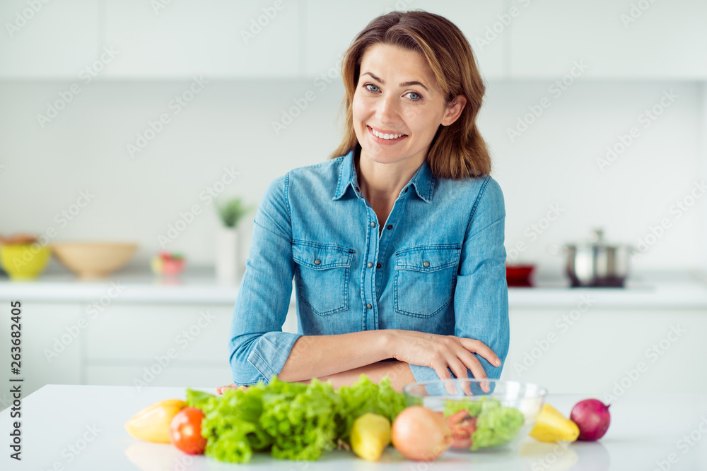 Portrait of her she nice lovely charming cute attractive cheerful cheery positive brown-haired lady ready to cook new dish in light white interior style kitchen Portrait of her she nice lovely charming cute attractive cheerful cheery positive brown-haired lady ready to cook new dish in light white interior style kitchen
