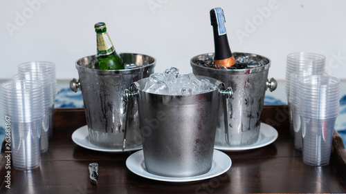 Ice bucket with a bottle on the back and a pasted glass