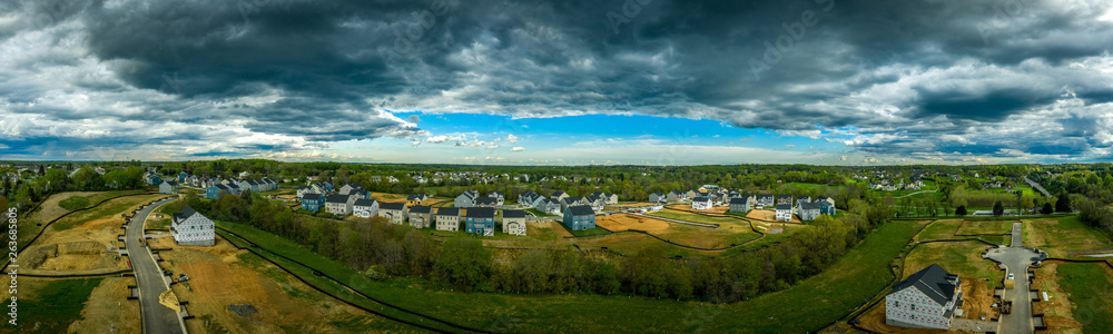 Aerial panorama of new construction luxury residential neighborhood street with American single family homes in Maryland USA real estate Aerial panorama of new construction luxury residential neighborhood street with American single family homes in Maryland USA real estate