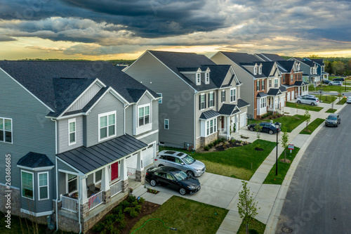 Aerial view of typical American new construction neighborhood street in Maryland for the upper middle class, single family homes USA real estate with dramatic sky