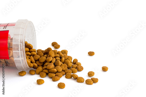 dry cat food is poured from a plastic measuring Cup for different types of cats