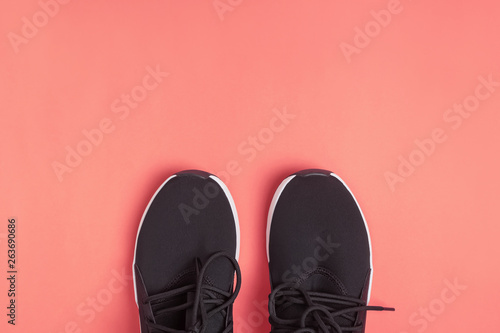 Black sneakers for run or fitness on bright yellow background,