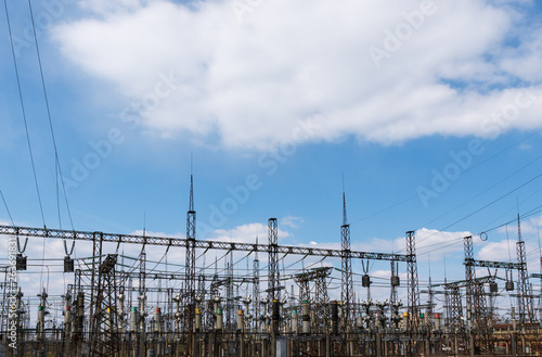 High power electricity poles in urban area. Energy supply, distribution of energy, transmitting energy, energy transmission, high voltage supply concept photo