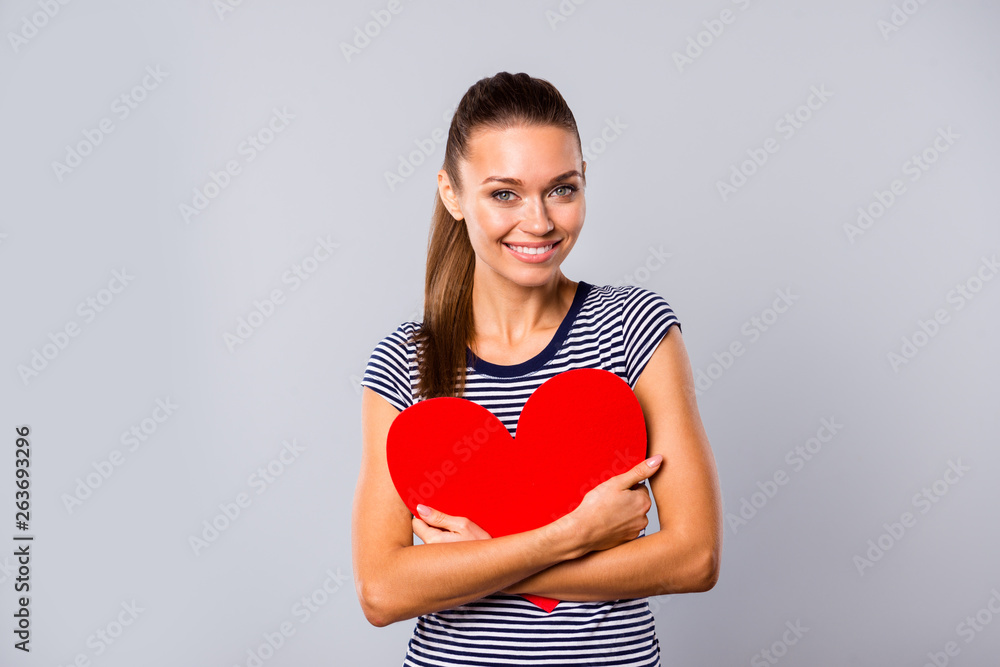 Close up photo beautiful amazing she her lady hold arms hands large red paper heart shape figure postcard boyfriend husband gift celebration wear blue white striped t-shirt isolated grey background Close up photo beautiful amazing she her lady hold arms hands large red paper heart shape figure postcard boyfriend husband gift celebration wear blue white striped t-shirt isolated grey background