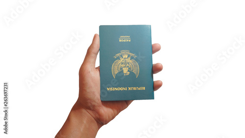 Close up hand holding indonesian passport isolated on white background - Image