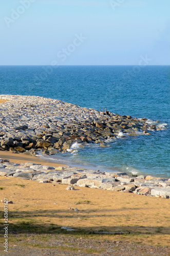 Rock formation at the beach with blue skies © Hazmi