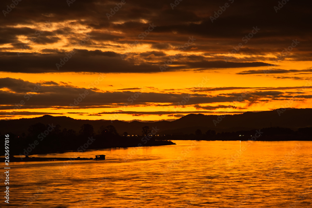 In the morning, the sun rises on the banks of the Mekong River in the Golden Triangle, Chiang Rai, Thailand.