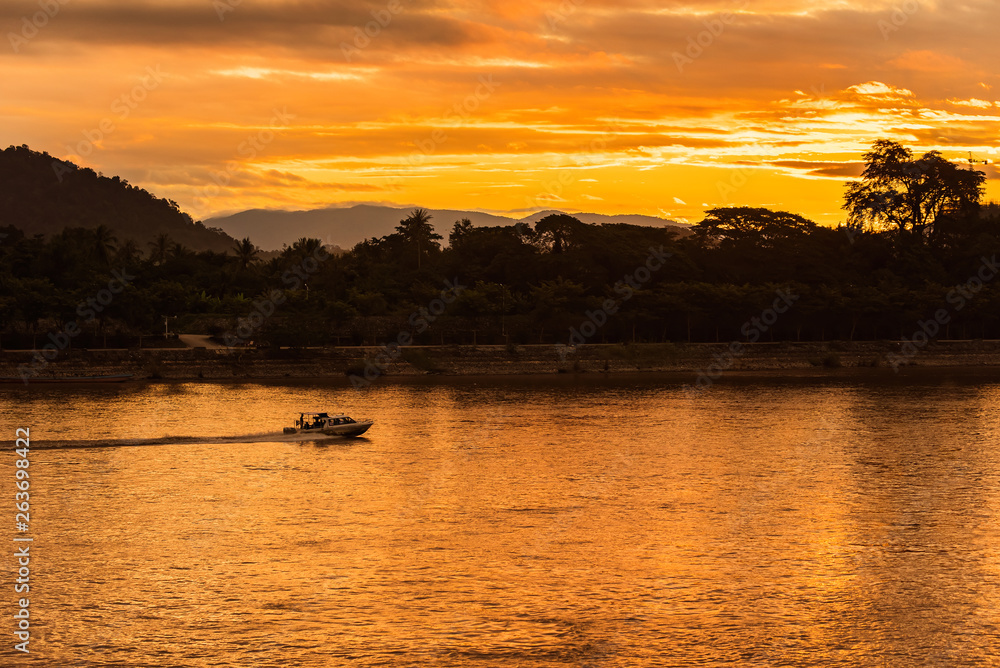 The ship is sailing in the Mekong River in In the morning, the sunrise in the Golden Triangle, Chiang Rai, Thailand The ship is sailing in the Mekong River in In the morning, the sunrise in the Golden Triangle, Chiang Rai, Thailand