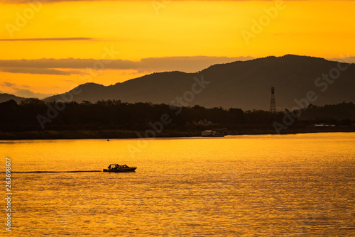 The ship is sailing in the Mekong River in In the morning, the sunrise in the Golden Triangle, Chiang Rai, Thailand