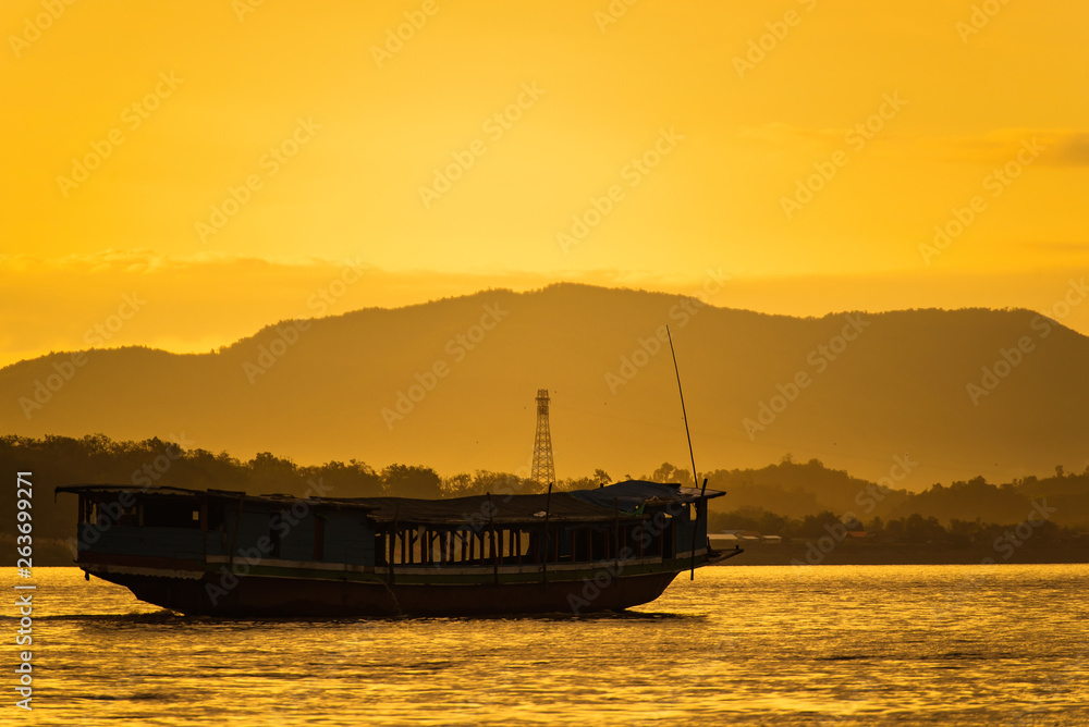 The ship is sailing in the Mekong River in In the morning, the sunrise in the Golden Triangle, Chiang Rai, Thailand
