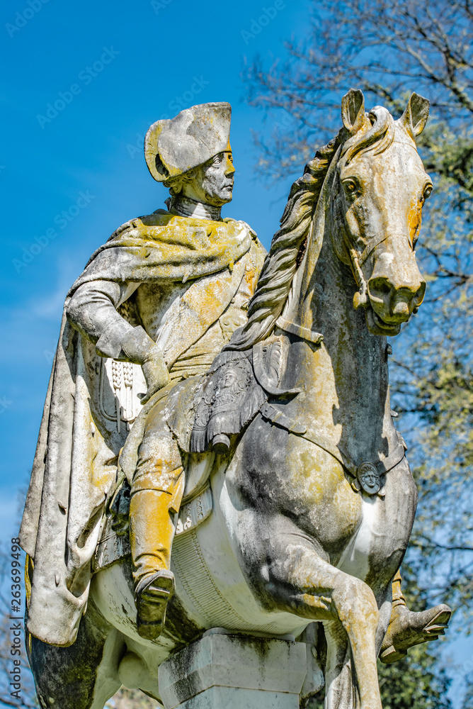 Fototapeta premium Very old statue of Prussian King Frederick the Great covered with moss and lichen, Potsdam, Germany