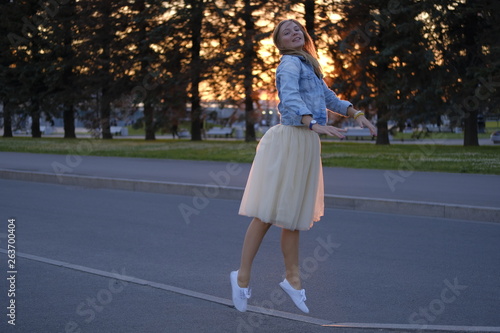 Beautiful girl posing in the streets of city at sunset
