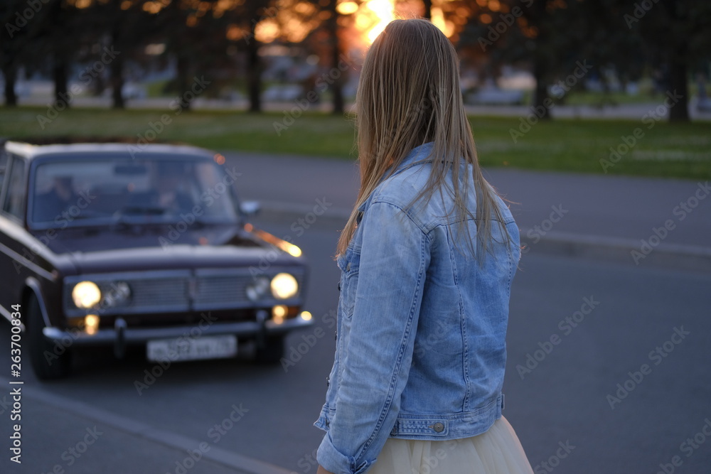 Beautiful girl posing in the streets of city at sunset Beautiful girl posing in the streets of city at sunset