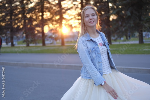 Beautiful girl posing in the streets of city at sunset