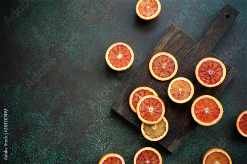 Red blood orange fruit on a dark green background. Oranges Slices. Healthy Food