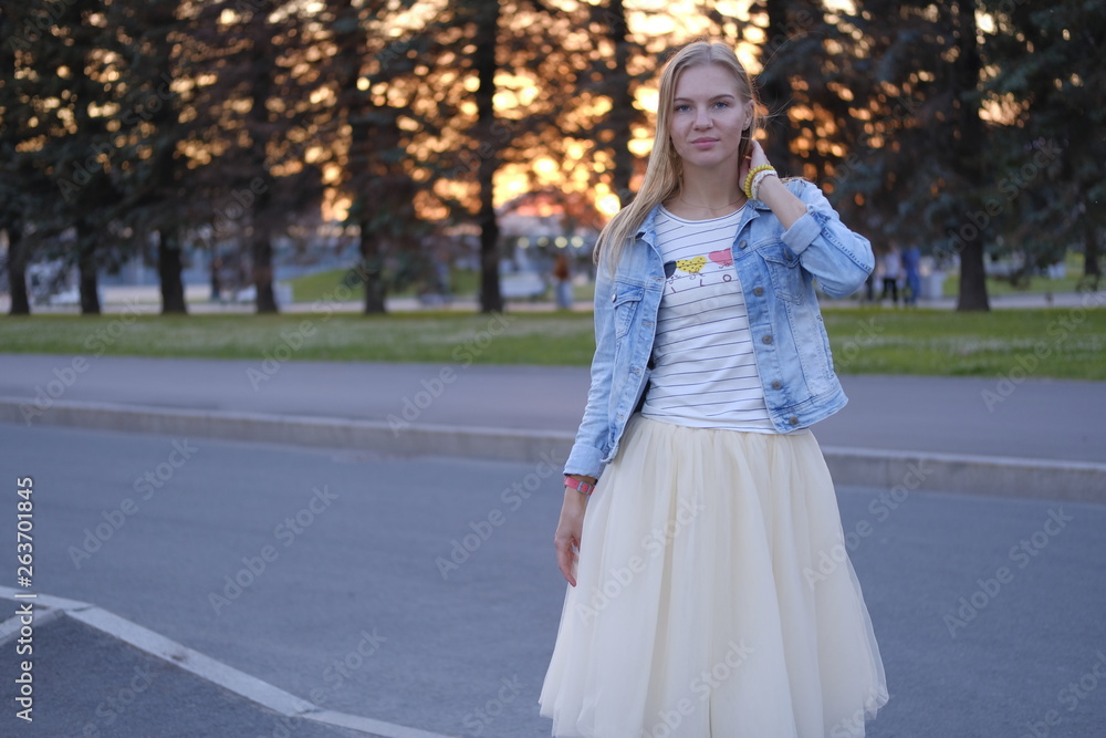 Beautiful girl posing in the streets of city at sunset Beautiful girl posing in the streets of city at sunset