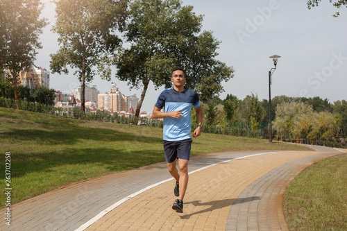 Healthy Lifestyle. Young man running in park confident