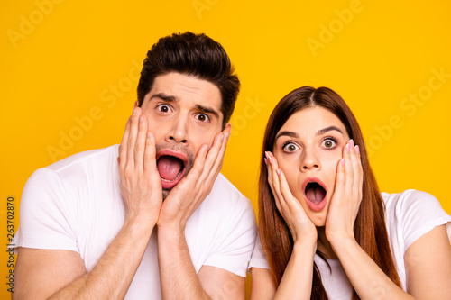 Close-up portrait of two nice attractive lovely charming worried people problem trouble stress opened mouth facial expression isolated over vivid shine bright yellow background