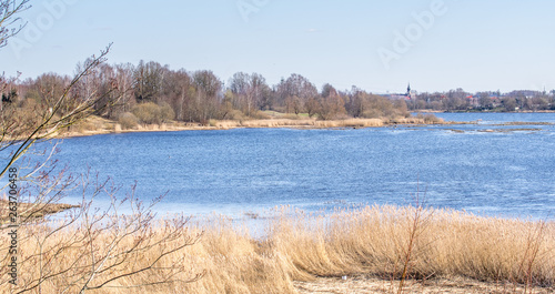 View of the river in early spring on a sunny day.