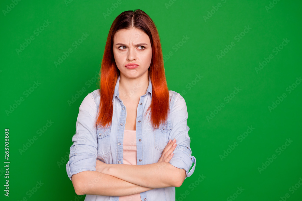 Close up photo beautiful funny expression she her foxy lady arms crossed look offense empty space not speak tell talk to you your fault wear casual jeans denim shirt isolated green bright background Close up photo beautiful funny expression she her foxy lady arms crossed look offense empty space not speak tell talk to you your fault wear casual jeans denim shirt isolated green bright background