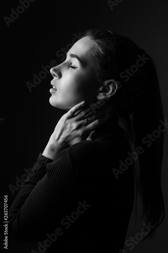 Beautiful girl in profile. Black and white. Low key
