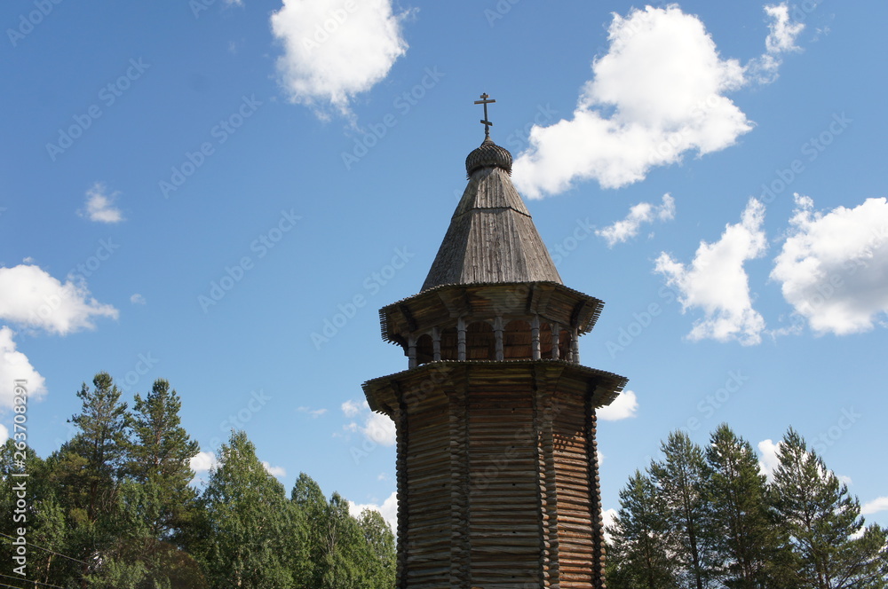 Fototapeta premium Wooden old orthodoxy church withsky and trees in Malye Karely Museum of wooden architecture in Arkhangelsk at the north of Russia 