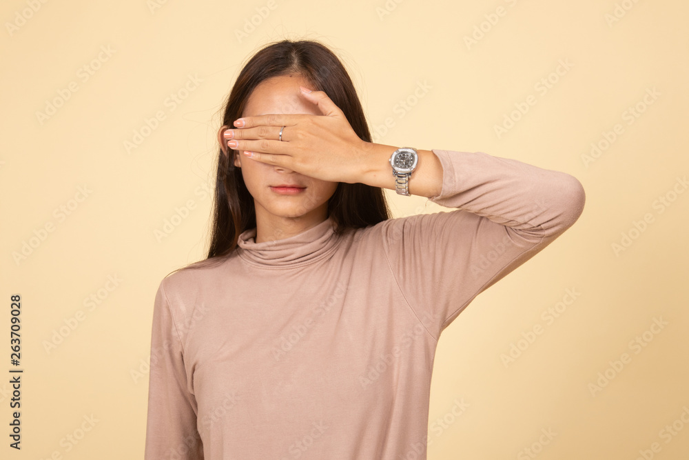 Young Asian woman close her eyes with hand. Young Asian woman close her eyes with hand.