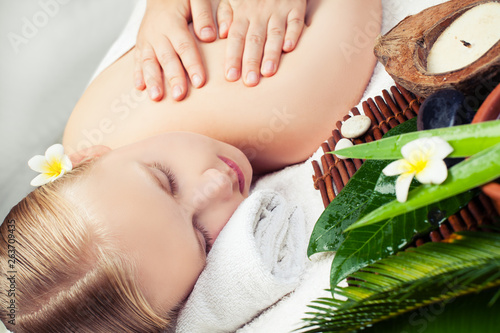 Spa relax massage concept. Beautiful young woman getting spa massage