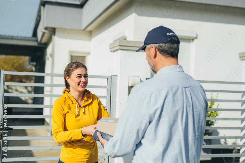 delivery man delivering parcel box to recipient - courier service concept delivery man delivering parcel box to recipient - courier service concept