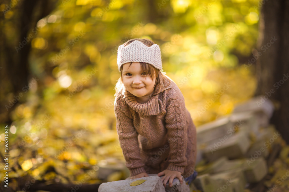 girl child plays in the forest in knitted tunic girl child plays in the forest in knitted tunic