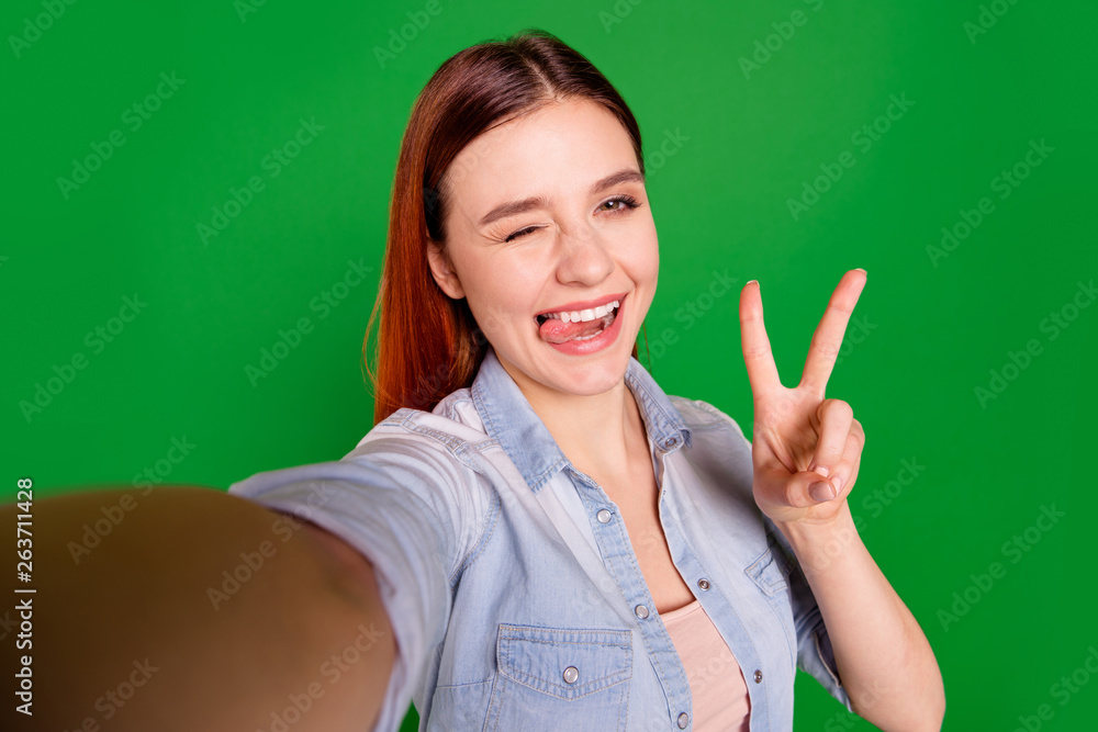 Self-portrait of her she nice-looking attractive cute charming lovely cheerful cheery girl having fun showing v-sign grimacing isolated over bright vivid shine green background Self-portrait of her she nice-looking attractive cute charming lovely cheerful cheery girl having fun showing v-sign grimacing isolated over bright vivid shine green background