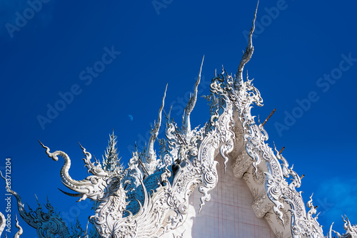 Decoration on top of roof at Wat Rong Khun Chiang Rai province Thailand.