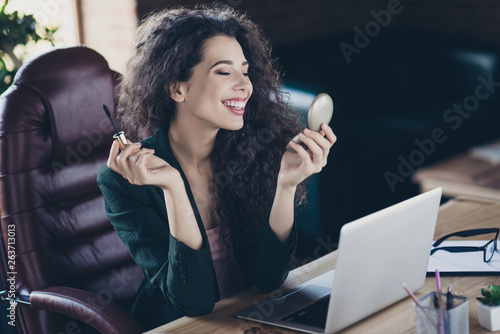 Close up photo of pretty maketer freelance do maquillage feel satisfied enjoy use want be fabulous have freeb time sit chair dressed black blazer have desk in comfy loft with specs modern technology