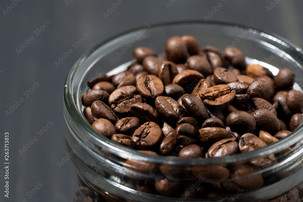 jar of coffee beans on a wooden background, concept photo, closeup jar of coffee beans on a wooden background, concept photo, closeup