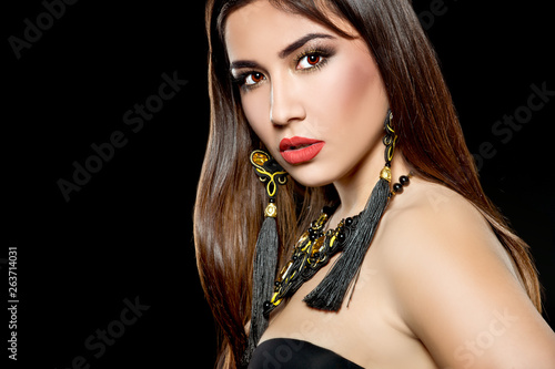 Beautiful woman with bright make up and with black earrings.  Bright make up. Series
