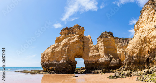 The rocky cliffs of Vale do Olival beach in Armacao de Pera, Portugal photo