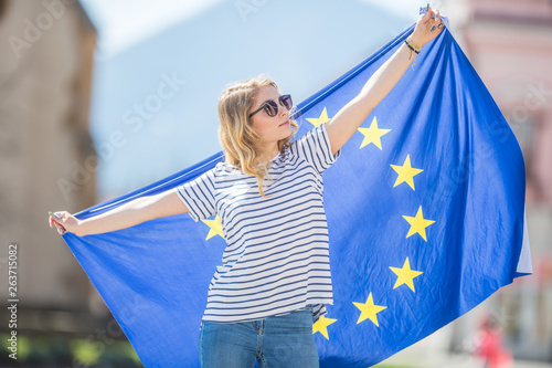 Attractive happy young girl with the flag of the European Union