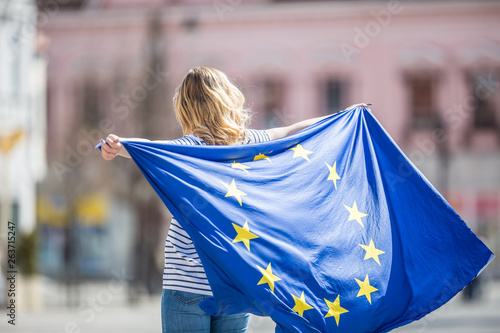 Attractive happy young girl with the flag of the European Union