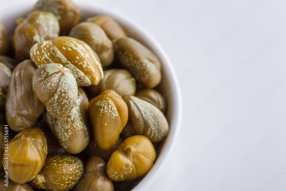 Pickled capers on a white acrylic background Pickled capers on a white acrylic background