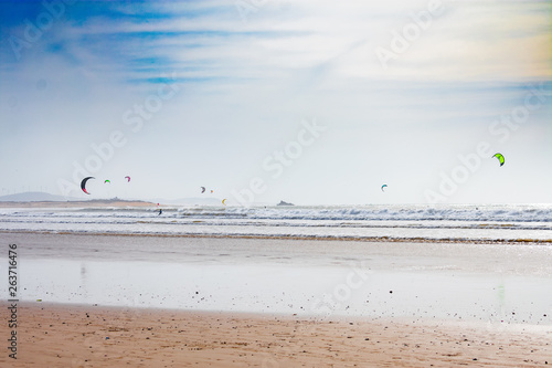 View of the Atlantic Ocean from a Beach in Essaouira Morocco with People Kite Surfing 