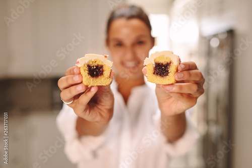 Confectioner showing stuffed cupcake