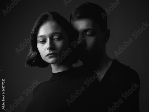 Young woman and young man in studio. Black and white