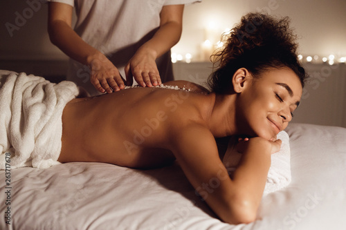 Salt scrub massage. Girl relaxing in health spa